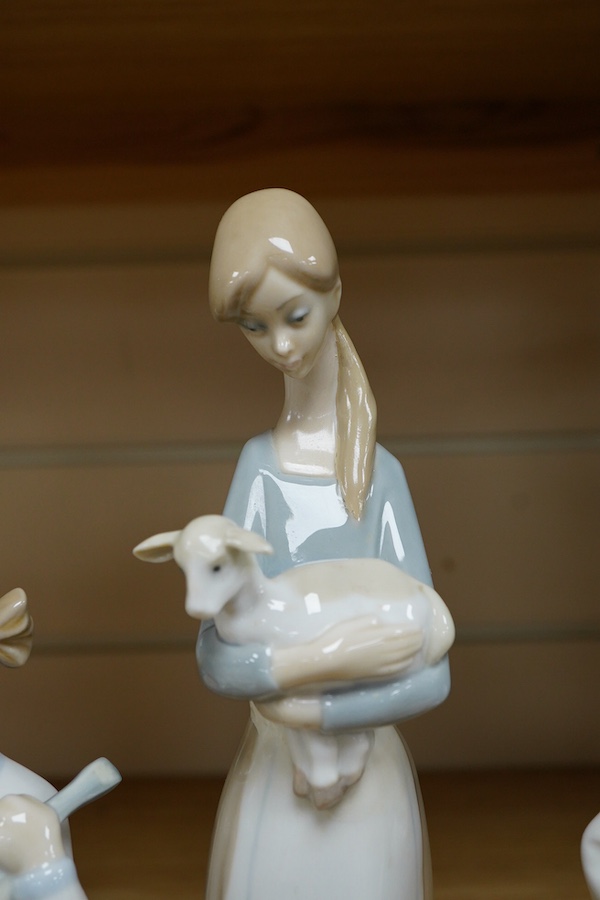 A Royal Doulton Images group and four LLadro figures